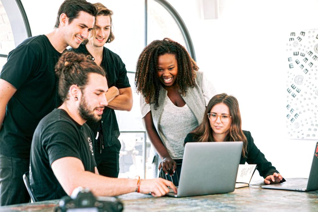 man-in-black-crew-neck-t-shirt-sitting-beside-woman-in-gray-crew-neck-t-shirt-3153201 Dynamic team of young adults collaborating on project in bright modern office environment.